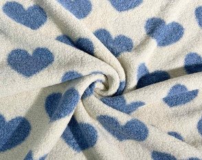 Teddy fabric Blue hearts on cream background Teddy fabric Blue hearts on cream background